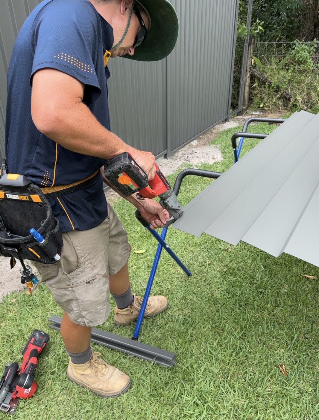 Elliot cutting a Colorbond fence sheet to length