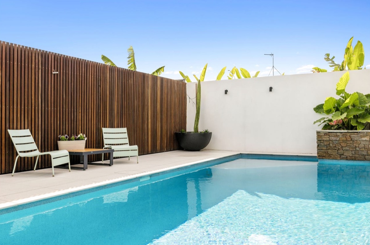 Premium feature fencing: stained hardwood batten pool screen on the Sunshine Coast